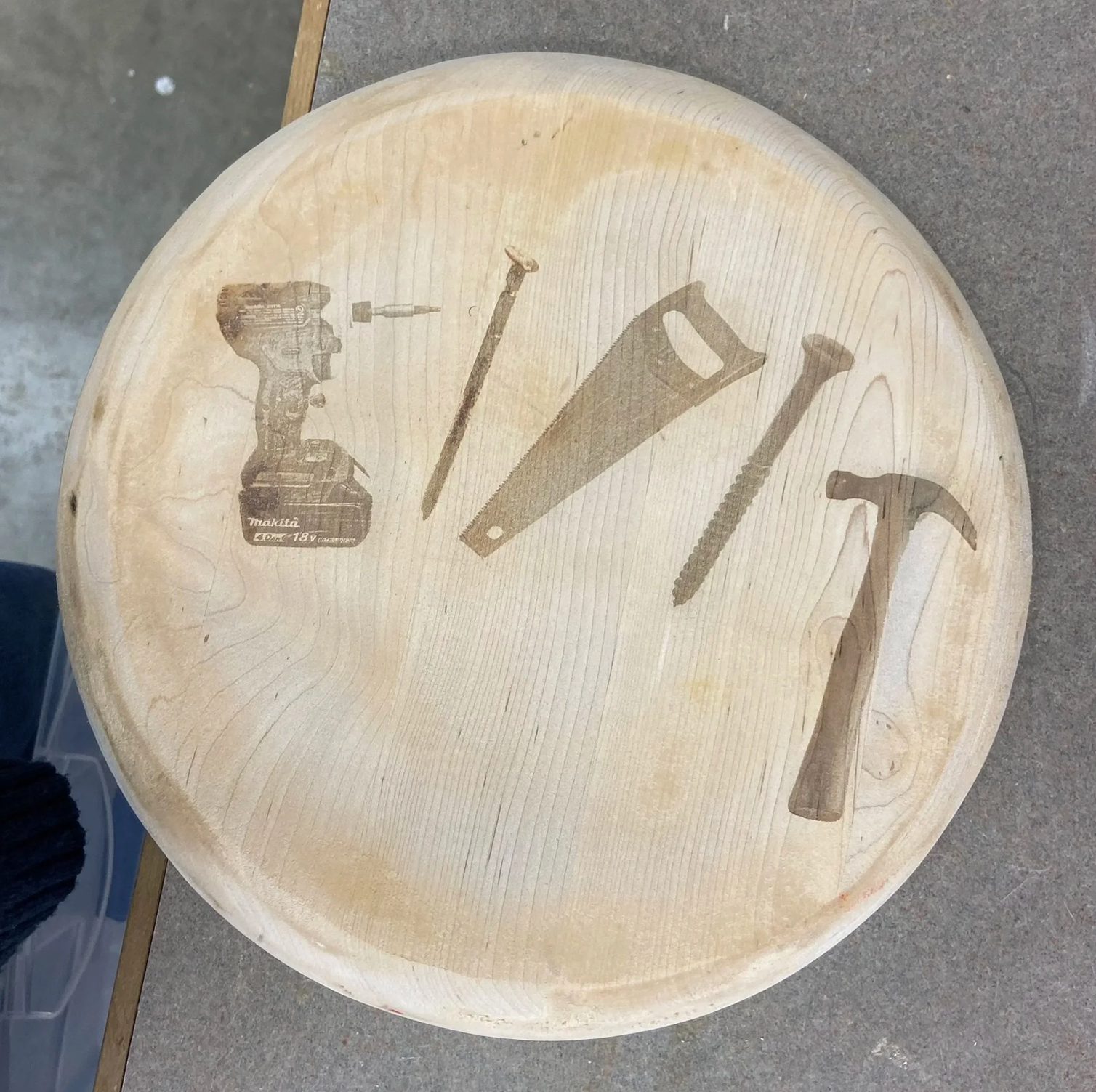 Laser-etched stool with workshop tool drawings